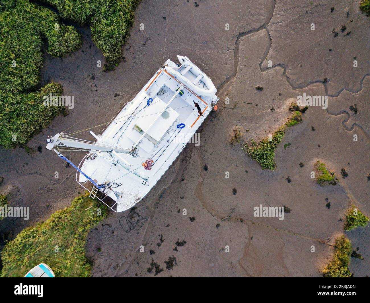 An aerial view of a catamaran sailing boat moored on a river bank Stock Photo