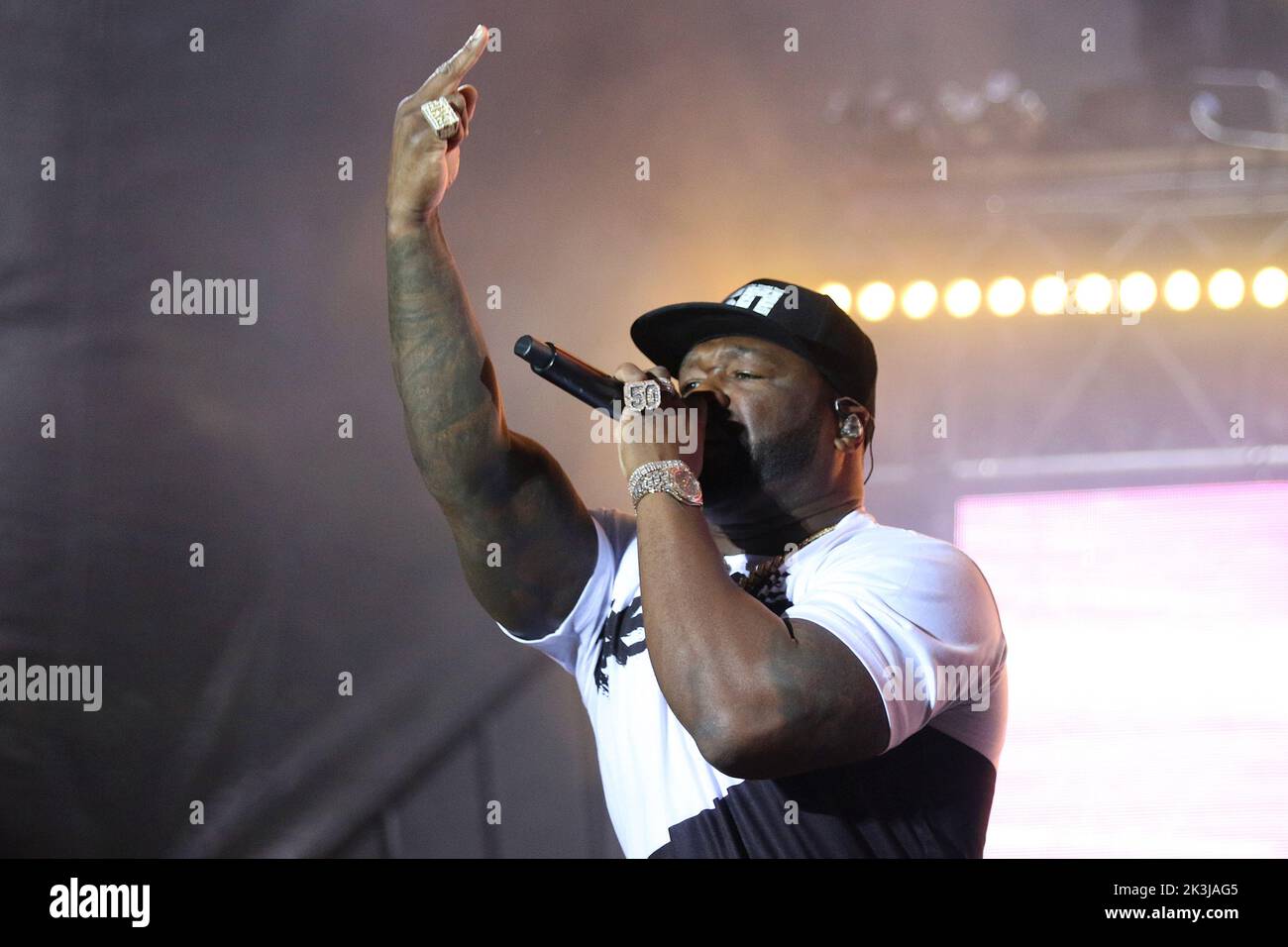 The portrait of famous American rapper 50 Cent while holding the microphone close to his mouth Stock Photo