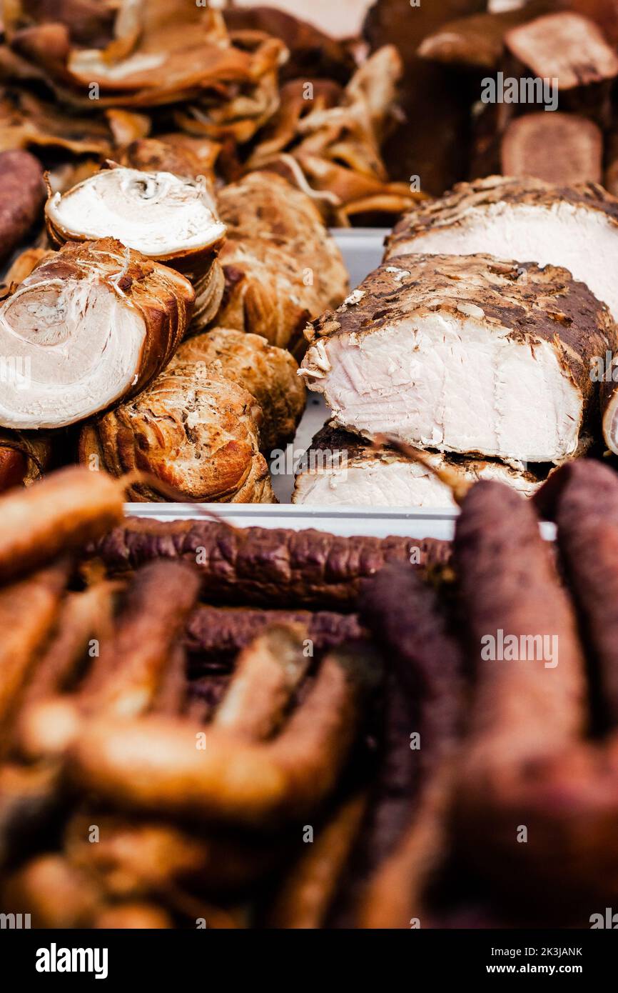 A vertical closeup shot of a board with different gourmet meats Stock Photo