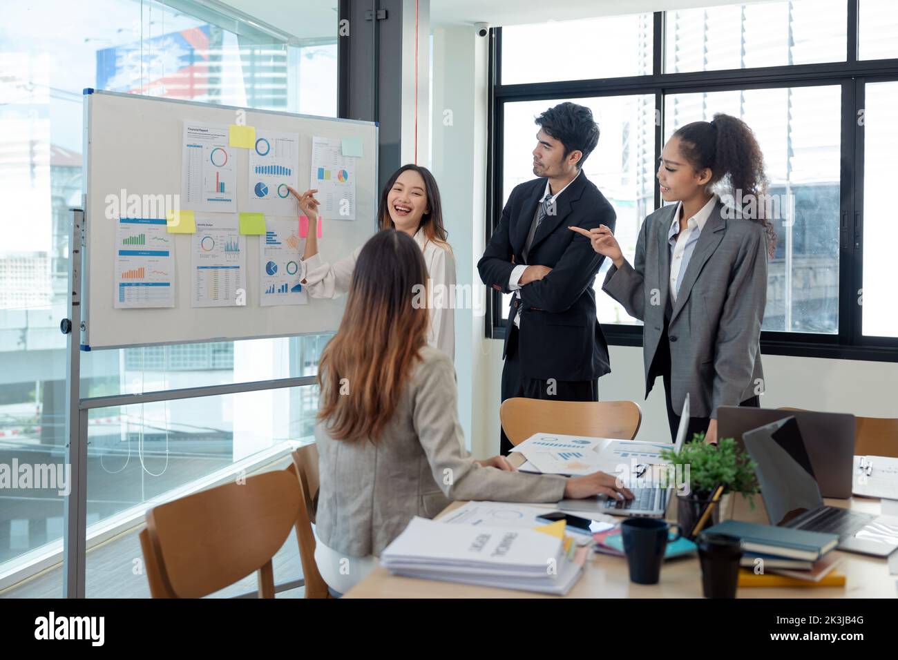 Diverse business people meeting new startup project pointing graph discussion and analysis data charts and graphs.Business finances and accounting Stock Photo