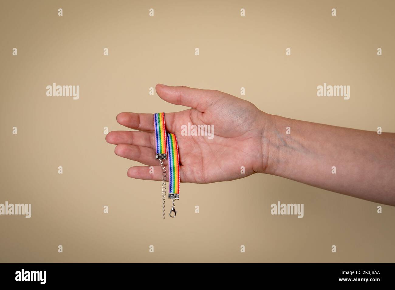 Colorful rainbow bracelet. Woman's hand and fingers. Stock Photo