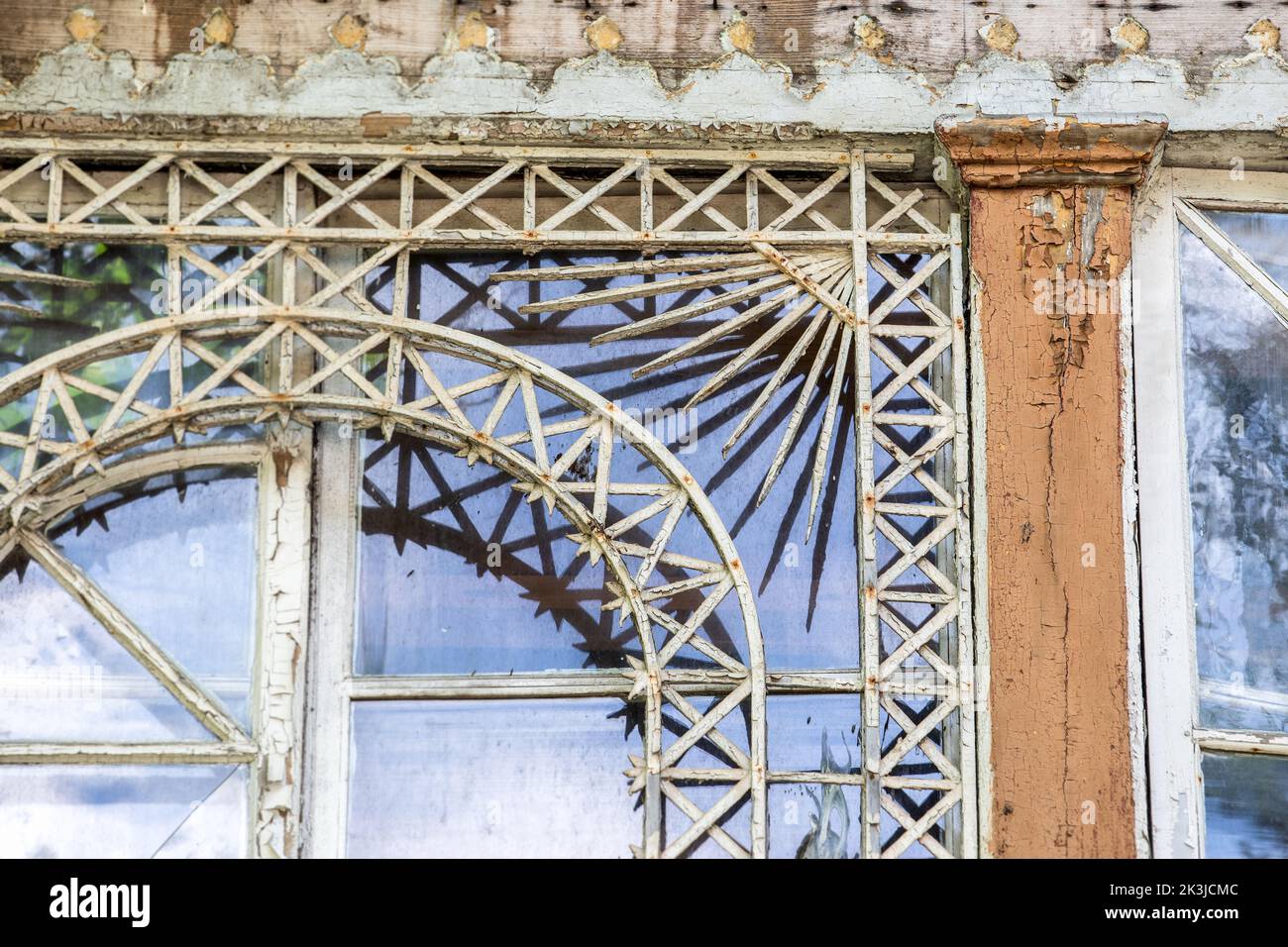 Old wooden window. Peeling paint and wooden details. Stock Photo