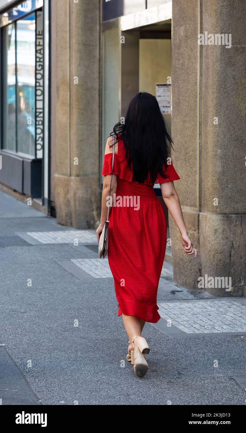 Prague - Czech Republic - 08 01 2020 Stylish fashionable woman in a red dress Stock Photo