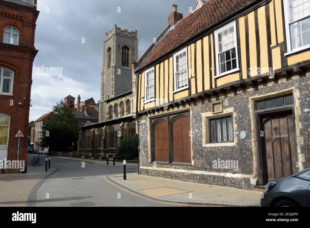 Colegate in Norwich, Norfolk, UK. In the foreground is Henry Bacon's House, with the church of St George Colegate in the background. Stock Photo
