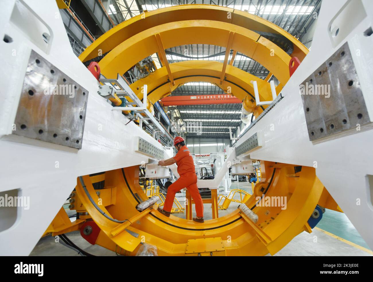 (220927) -- BEIJING, Sept. 27, 2022 (Xinhua) -- A worker installs a part of a tunnel boring machine at a production base in Xiaoshan District of Hangzhou City, east China's Zhejiang Province, June 27, 2022. (Photo by Long Wei/Xinhua) Stock Photo
