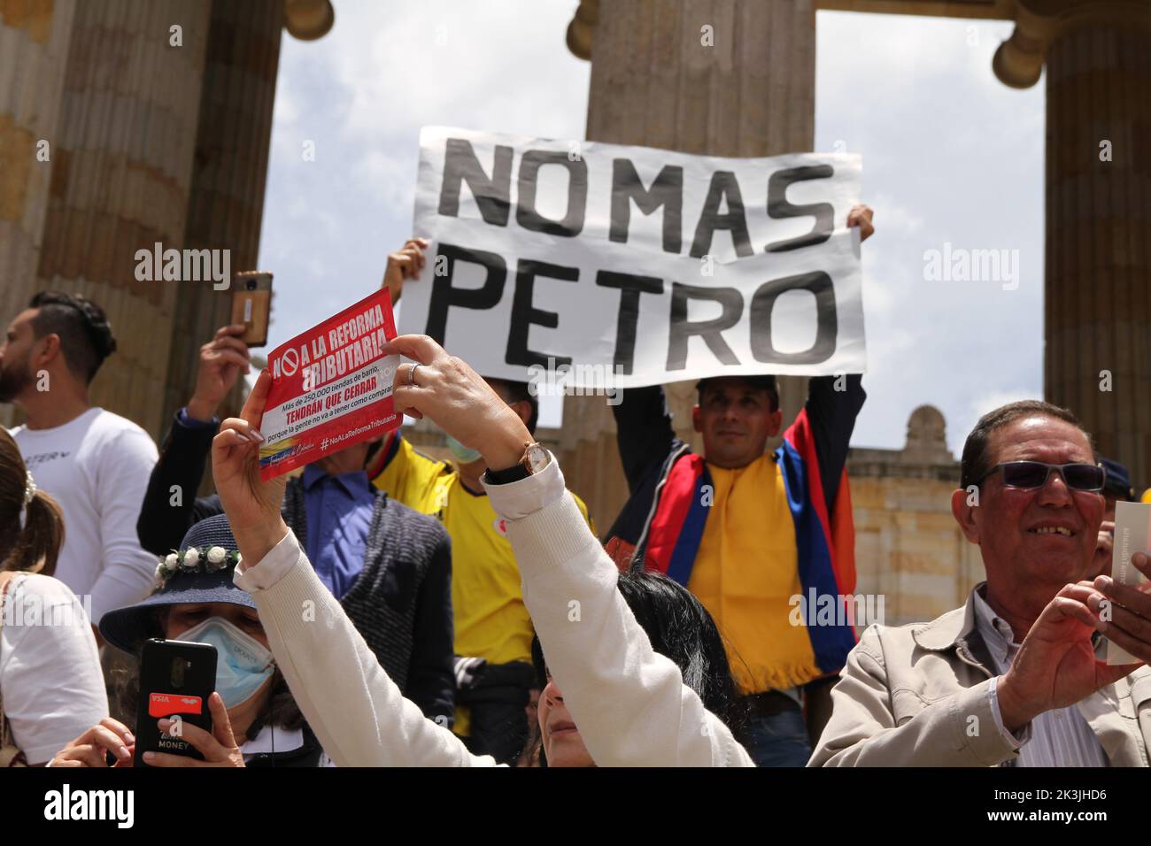 Demonstrators hold flyers and signs against the tax reform during the first antigovernment protest against left-wing president Gustavo Petro and his i Stock Photo