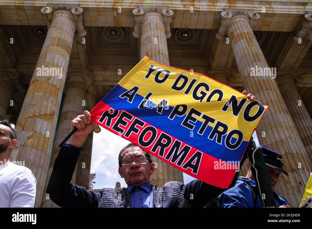 A demonstrator waves a Colombian flag that reads 'I say no to Petro's tax reform' during the first antigovernment protest against left-wing president Stock Photo