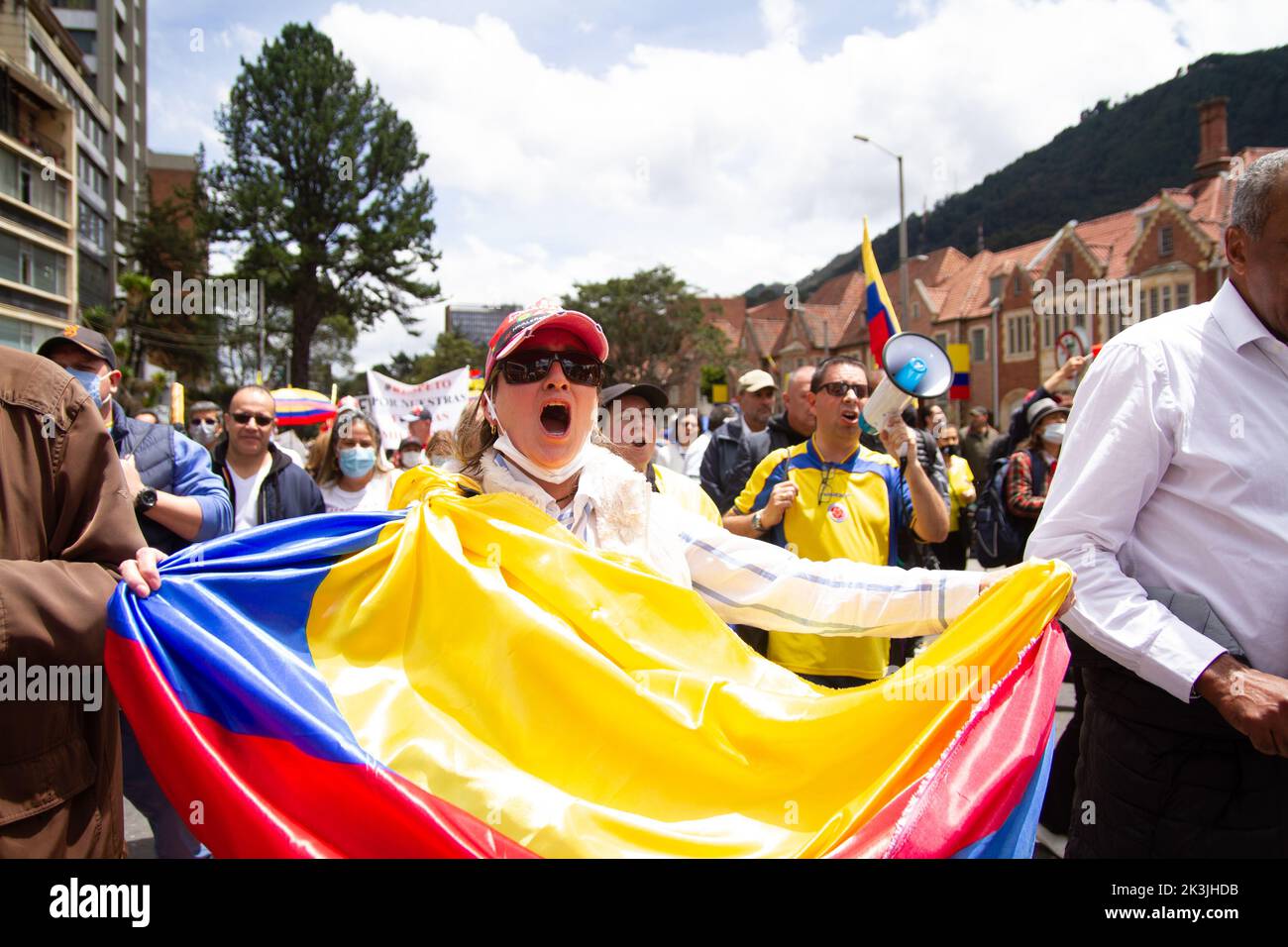 A demonstrator waves a Colombian flag during the first antigovernment protest against left-wing president Gustavo Petro and his initiative on a tax re Stock Photo