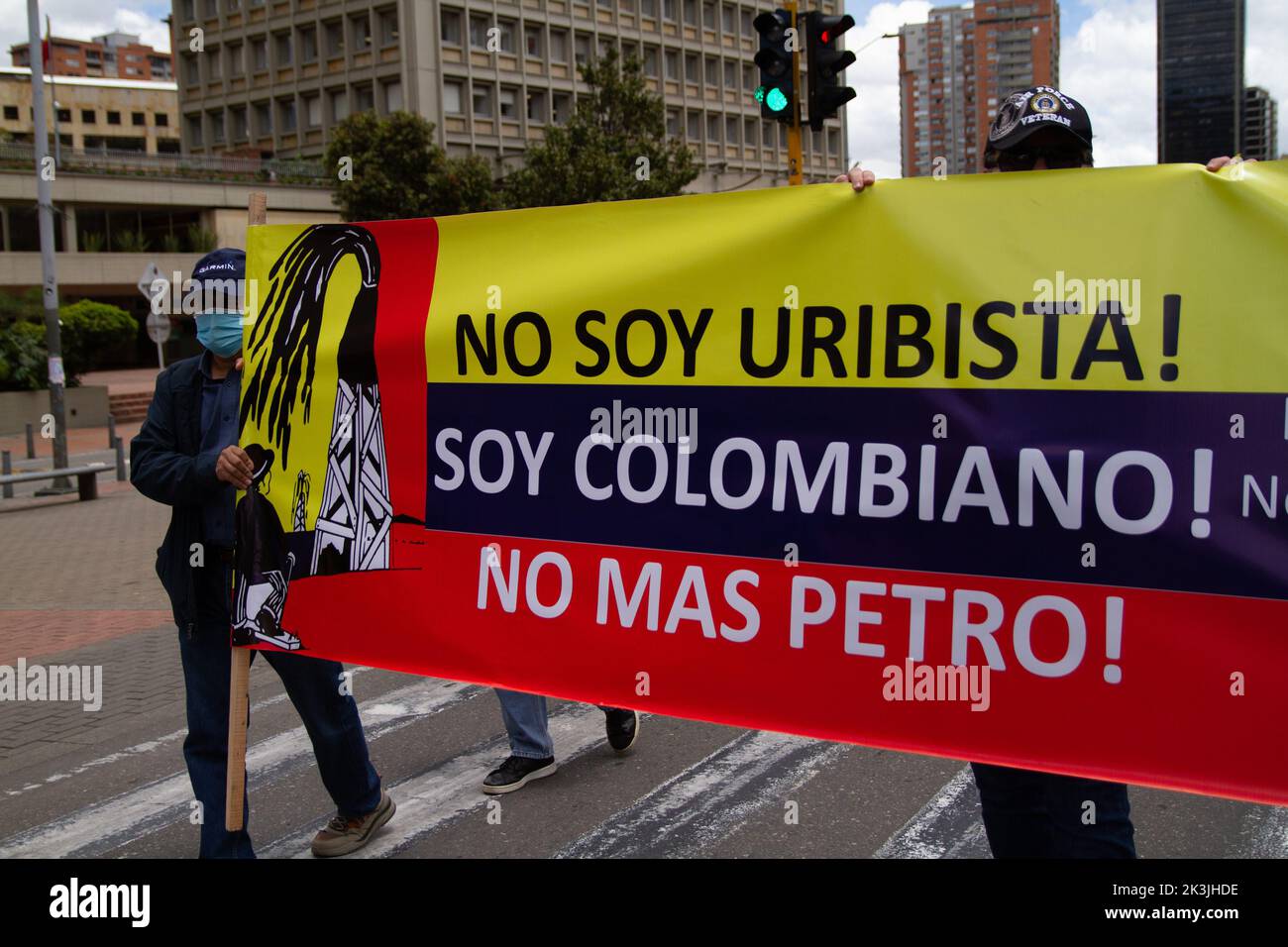 Demonstrators carry a sign that reads 'I am not Uribist, I am Colombian, no more Petro' during the first antigovernment protest against left-wing pres Stock Photo