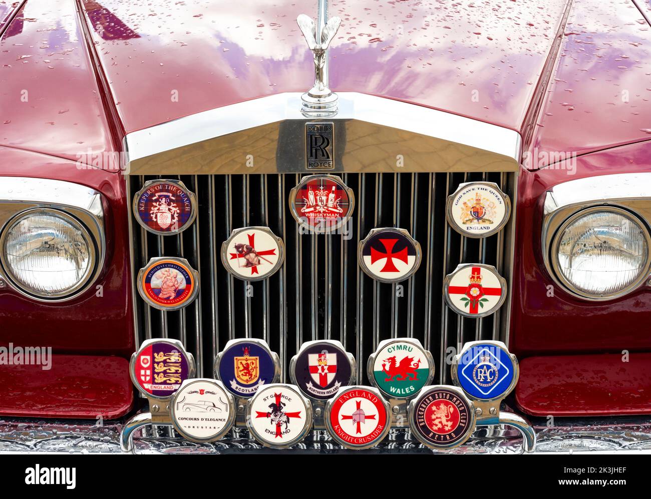 Classic Rolls Royce front radiator grille with variety of British badges Stock Photo