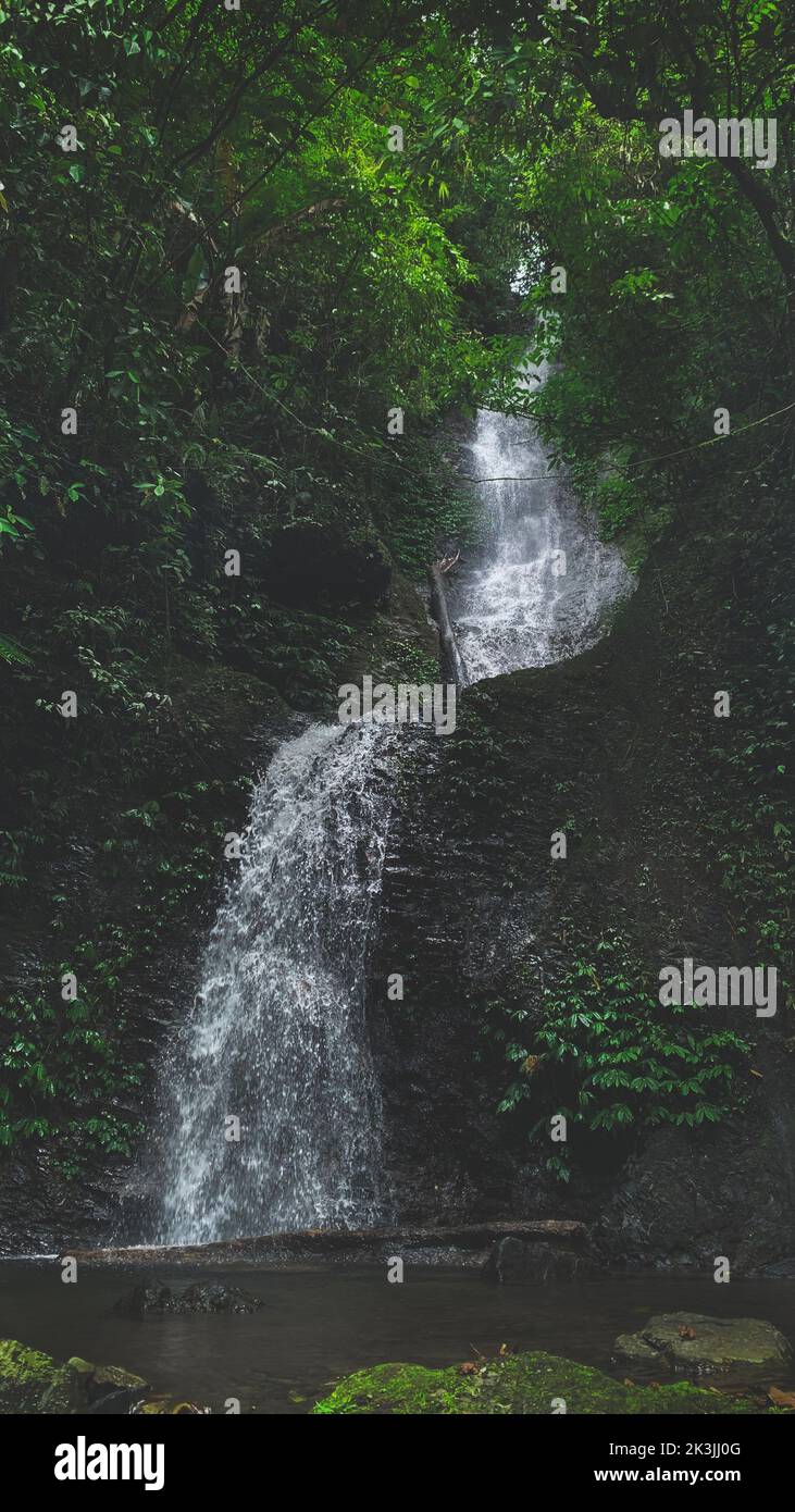 A vertical shot of a waterfall during a moody day Stock Photo - Alamy