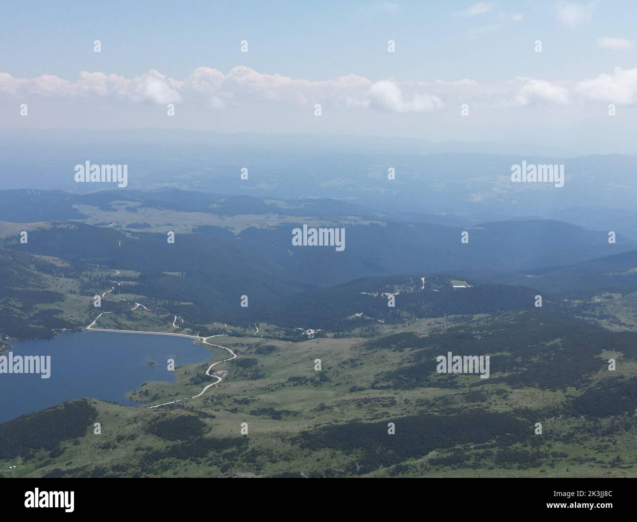 An aerial shot of the green landscapes, fields and a river under the ...