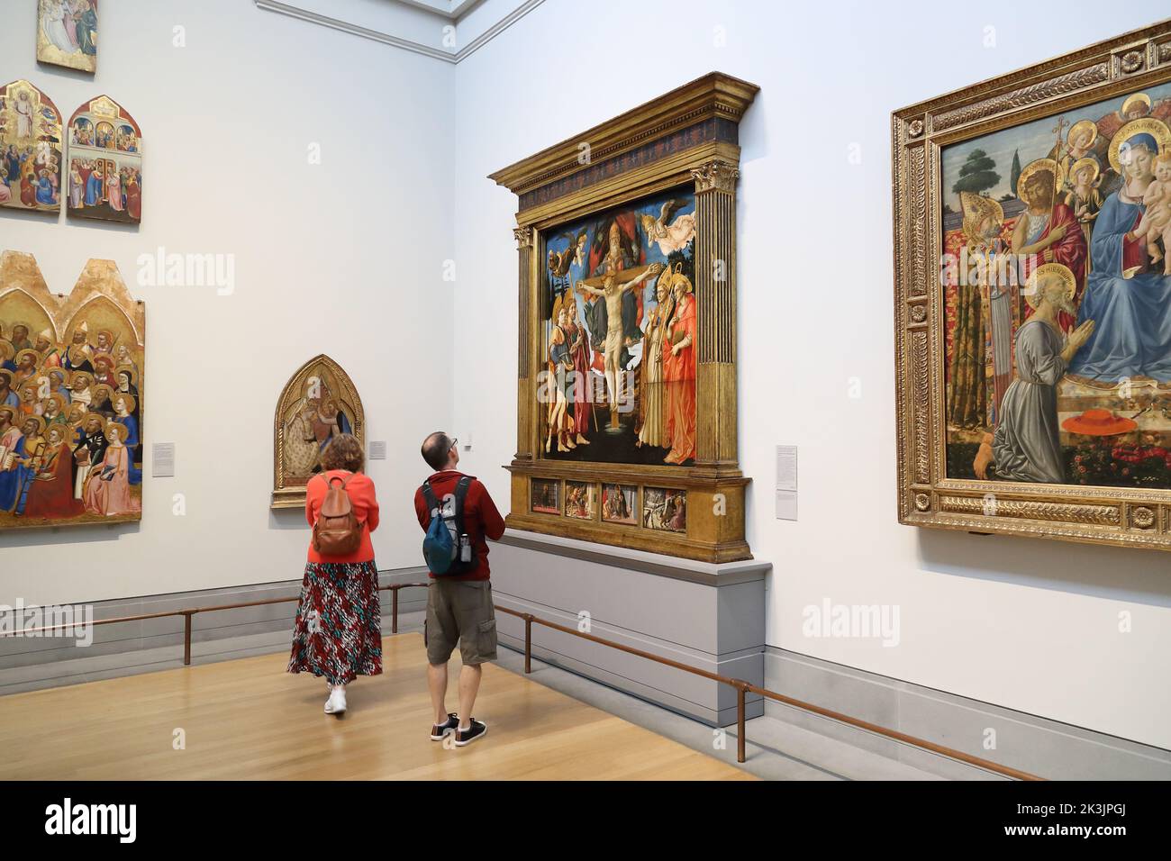 Visitors study Renaissance paintings in the National Gallery, London, UK Stock Photo