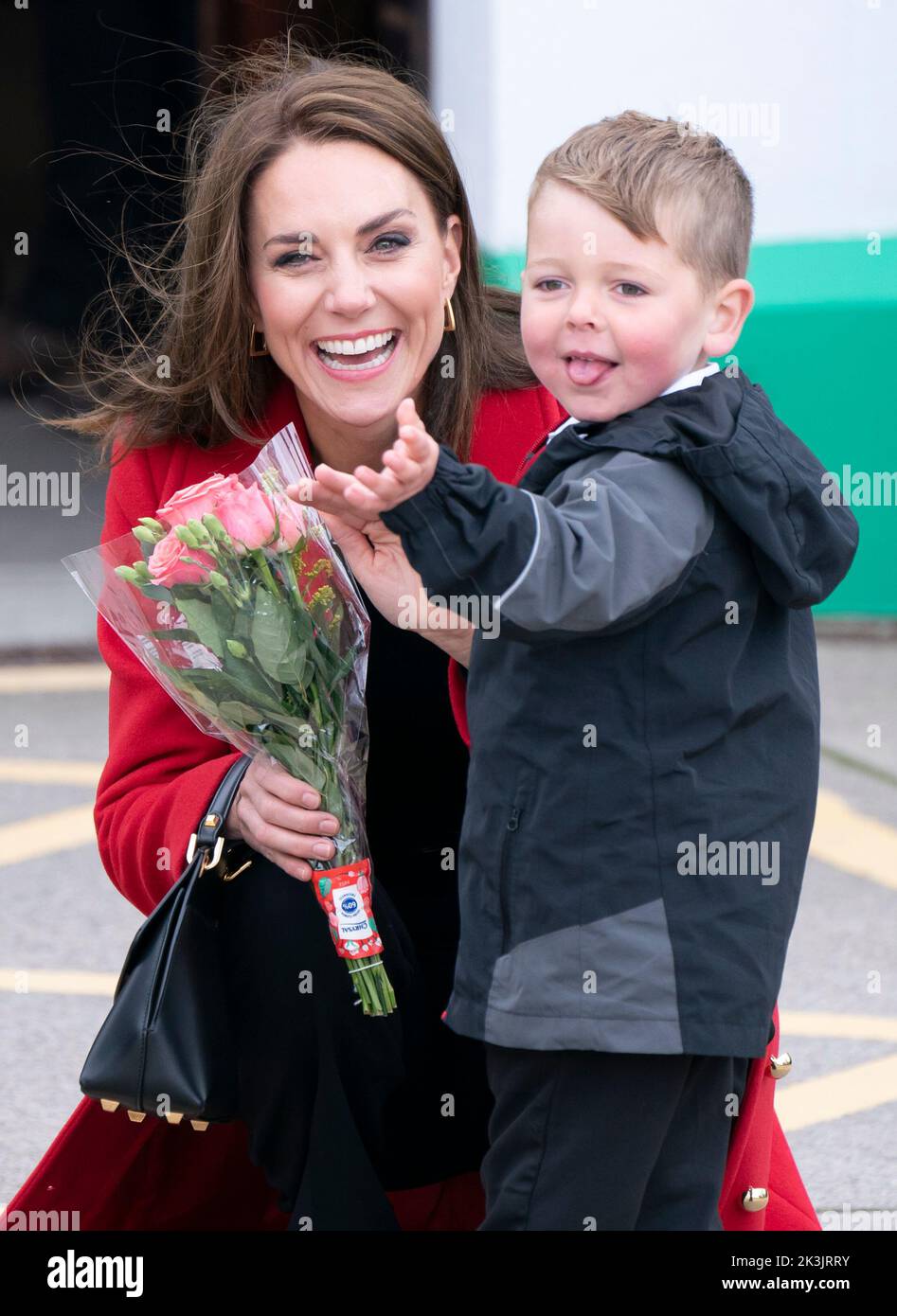 The Princess of Wales receives a posy of flowers from four-year-old Theo Crompton as she arrives for a visit to the RNLI Holyhead Lifeboat Station, in Holyhead, Wales, where with the Prince of Wales they are meeting crew, volunteers and some of those who have been supported by their local unit. Holyhead is one of the three oldest lifeboat stations on the Welsh coast and has a remarkable history of bravery, having received 70 awards for gallantry. Picture date: Tuesday September 27, 2022. Stock Photo