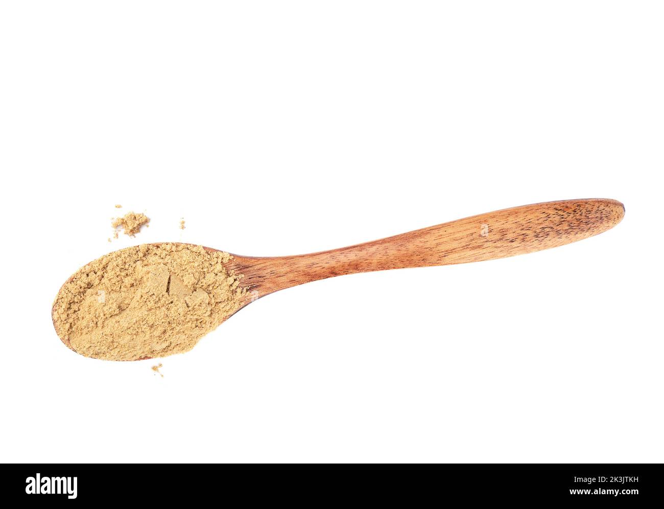 Powder of ground ginger on a wooden spoon over a white background. Top view, copy space. Stock Photo
