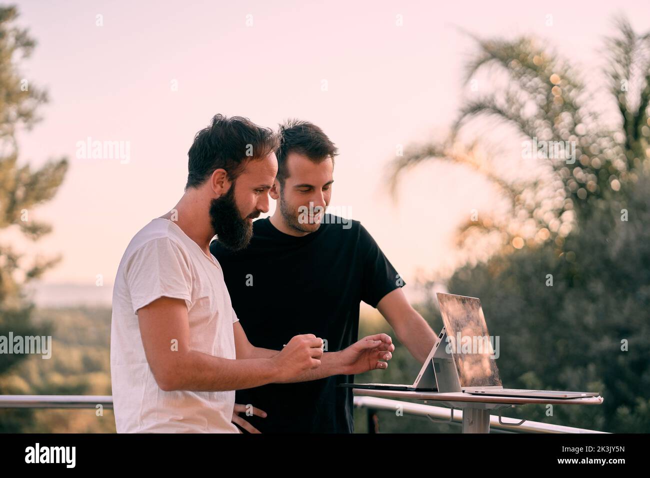 Two young entrepreneur men having a business meeting while working online with their tablets Stock Photo