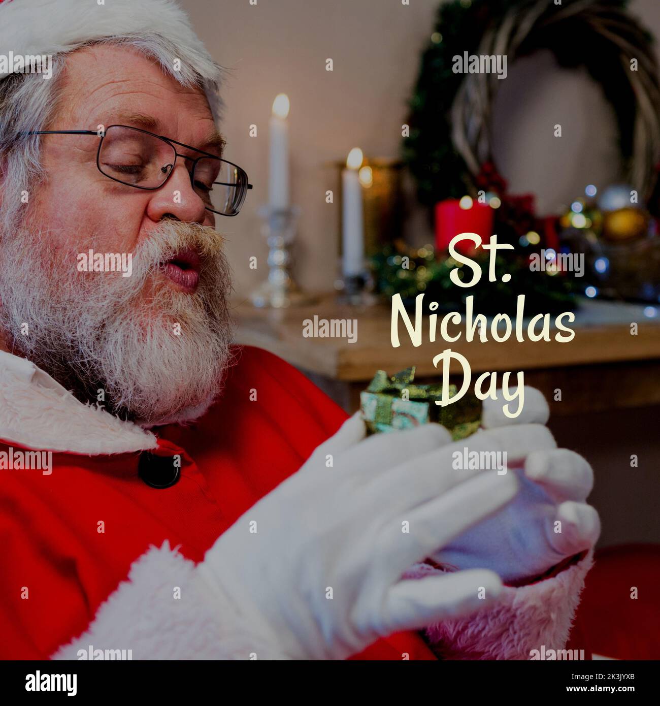 Composition of st nicholas day text over santa claus holding present Stock Photo