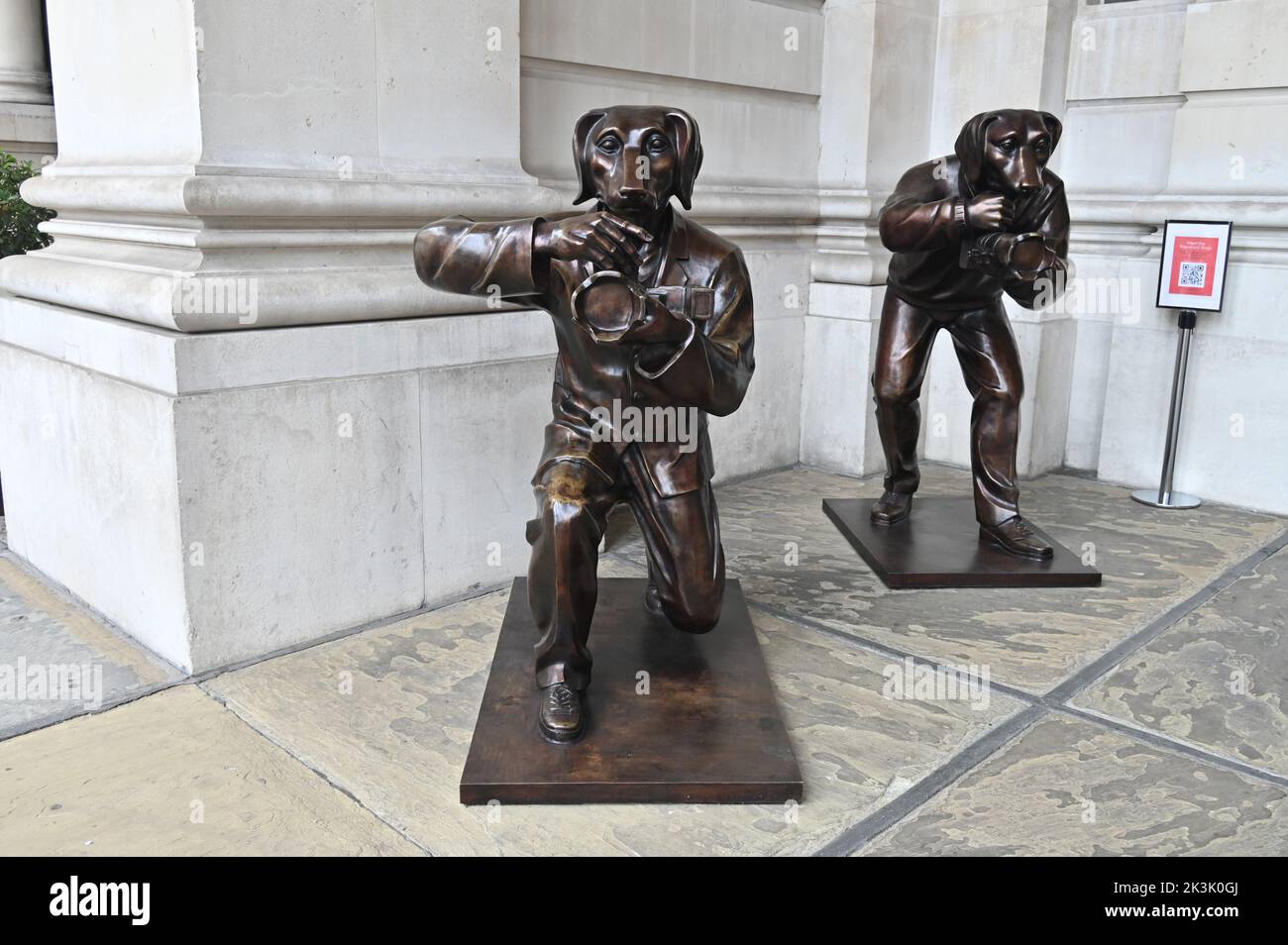 The paparazzi dogs are bronze sculptures created by Gillie and Marc stand outside the entrance to the Royal Exchange in the City of London Stock Photo
