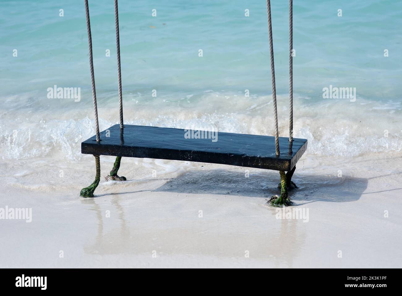 A swing on an exotic beach by the sea of a tropical island in Mexico Stock Photo