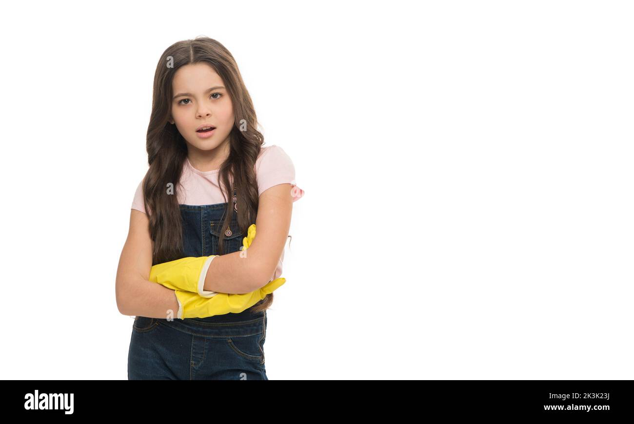 Serious girl keeping arms crossed in rubber gloves studio isolated on