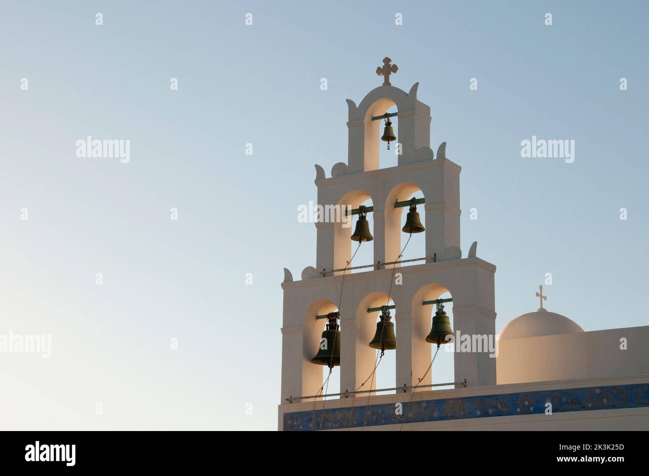Close-up of a bell tower on the island of Santorini in Greece at sunset Stock Photo