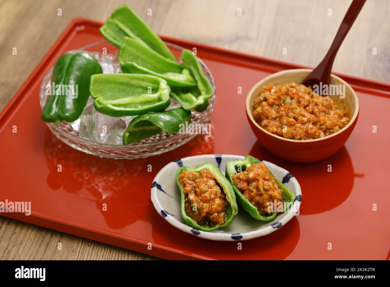 fresh green peppers(chilled in ice water) and Niku Miso (ground pork miso dip), a Japanese tavern appetizer Stock Photo