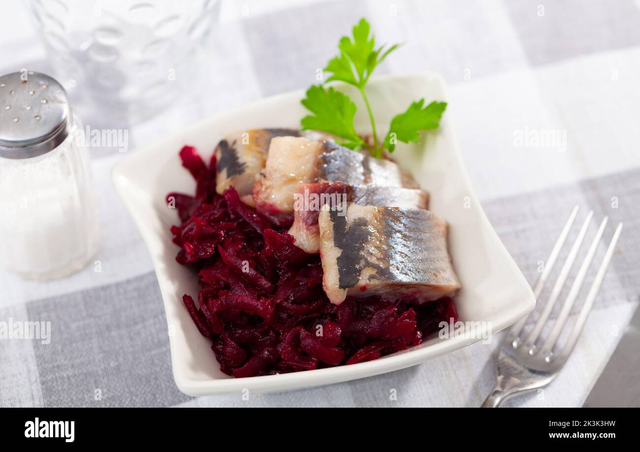 Sliced herring with grated beetroot served on table Stock Photo