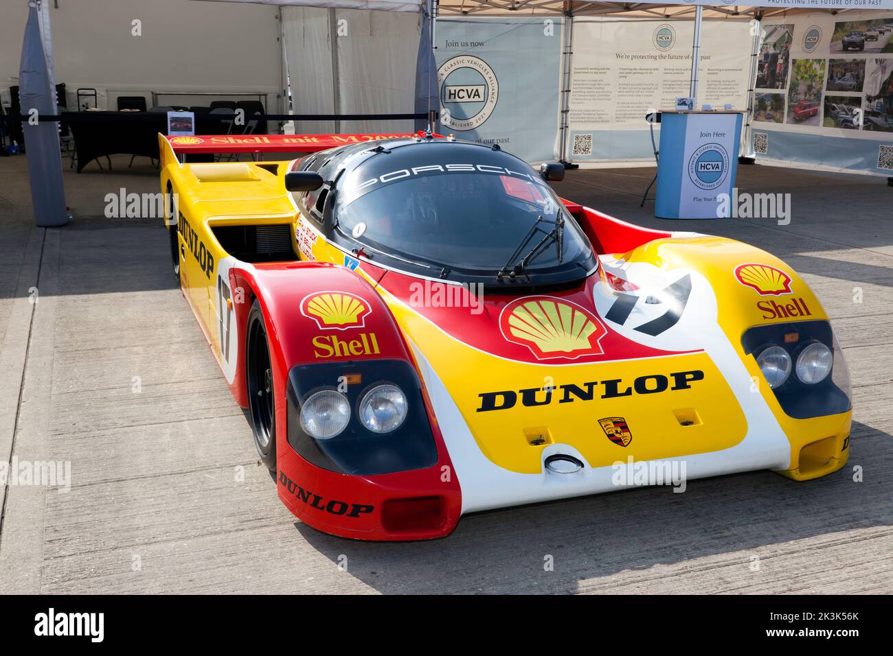 Three-quarters front view of a 1988, Porsche 962, in the livery of Shell Dunlop, on display at the 2022 Silverstone Classic Stock Photo