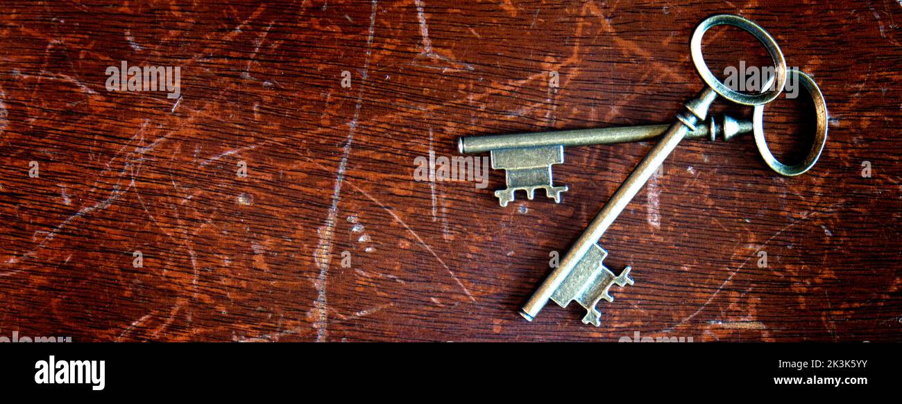 Old antique keys on worn wood texture background Stock Photo