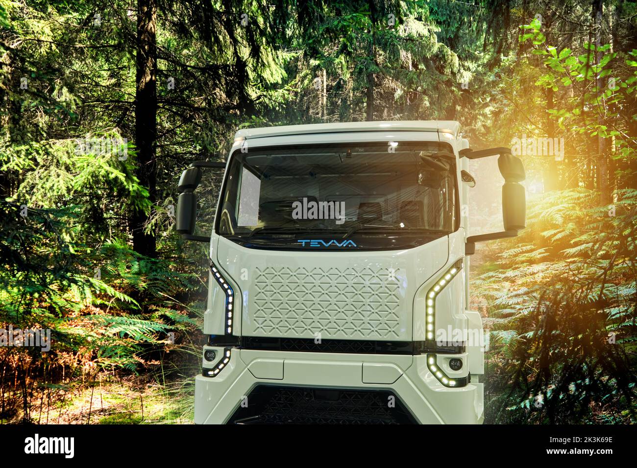 Tevva truck with hydrogen-based hydroelectric zero-emission propulsion composed in a green forest area, vehicle location Hannover, Germany, September Stock Photo