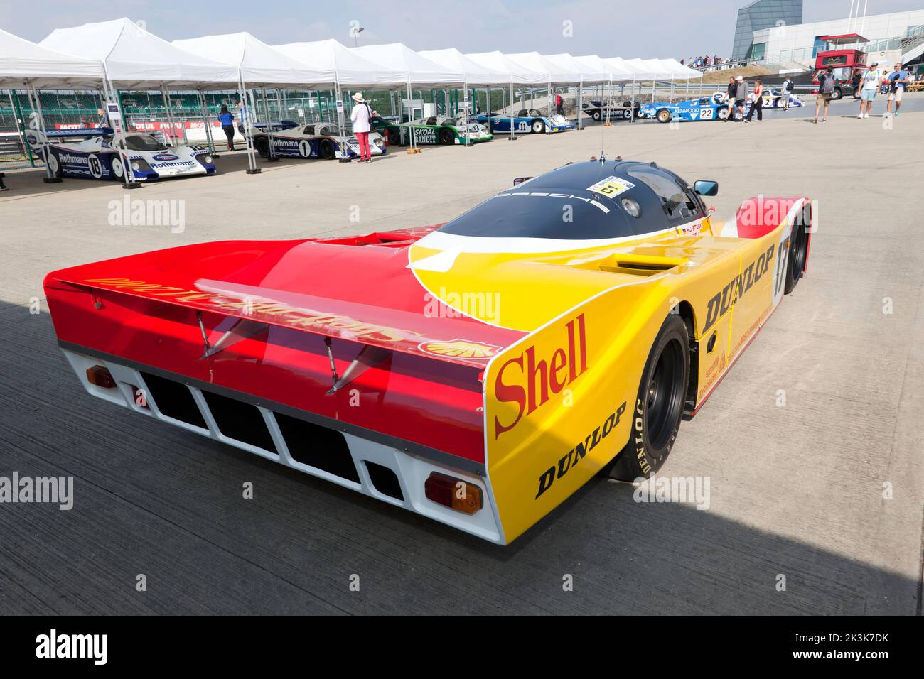 Three-quarters rear view of a 1988, Porsche 962, in the livery of Shell Dunlop, on display at the 2022 Silverstone Classic Stock Photo