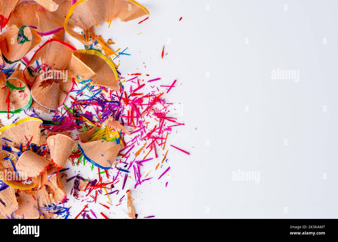 Top view of colored pencils with shavings and pencil sharpener over white  background. top view Stock Photo - Alamy