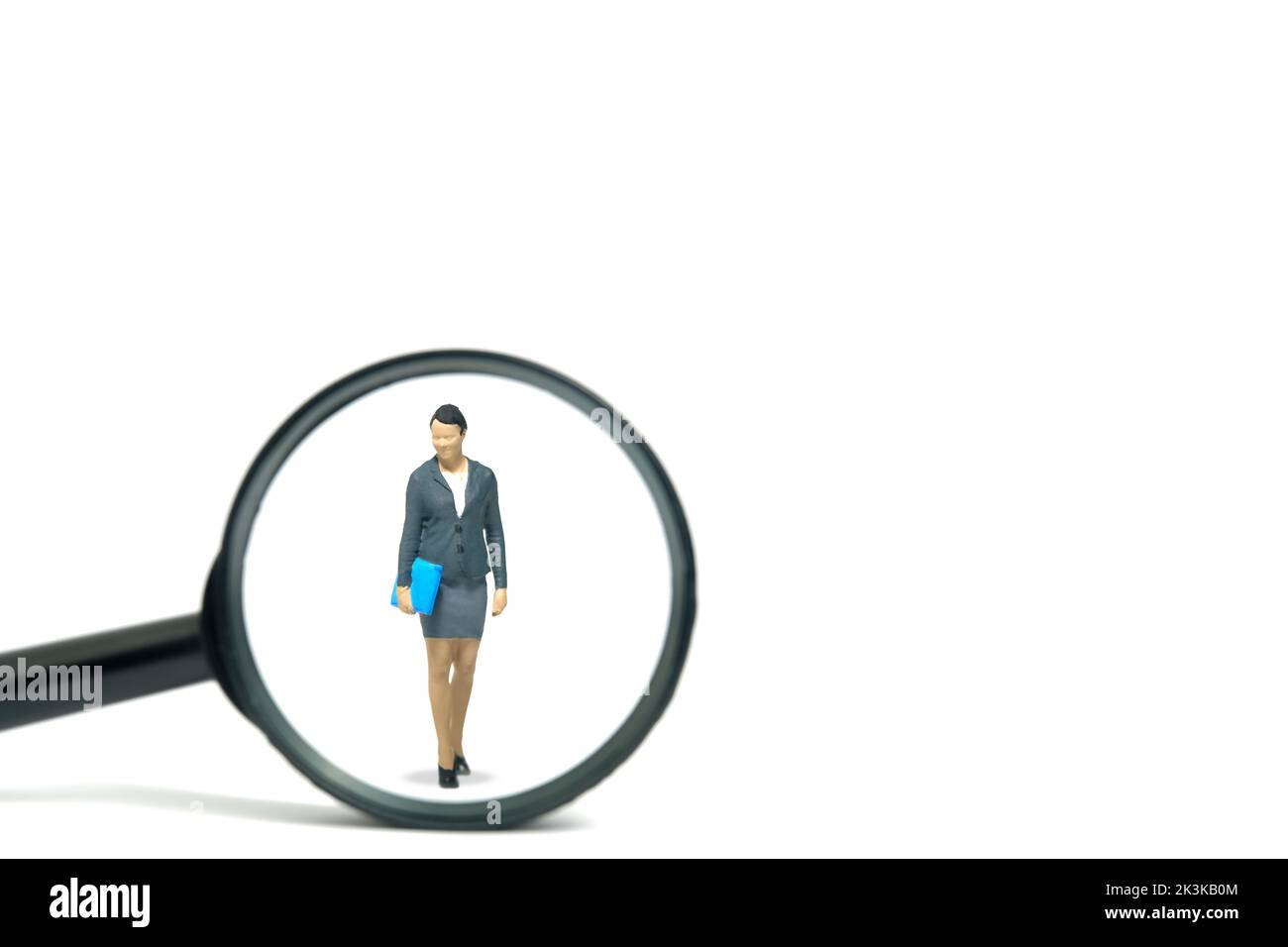Miniature people toy figure photography. Women leader search. A businesswoman standing with magnifier glass. Isolated on white background. Image photo Stock Photo