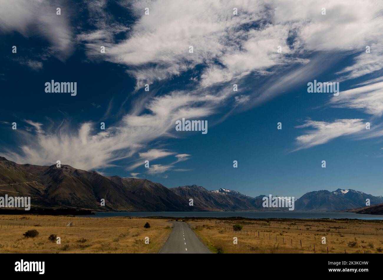 A country road leading to Lake Ohau near the Southern alps under the long white cloud near a small town of Twizel in the South island of New Zealand Stock Photo