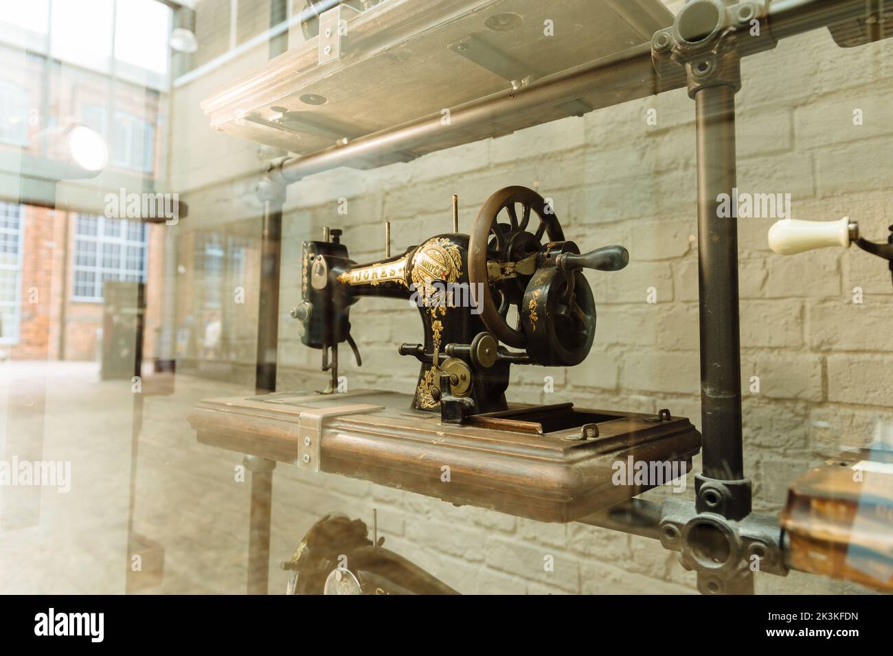 A vintage singer sewing machine in shop window display Stock Photo Alamy