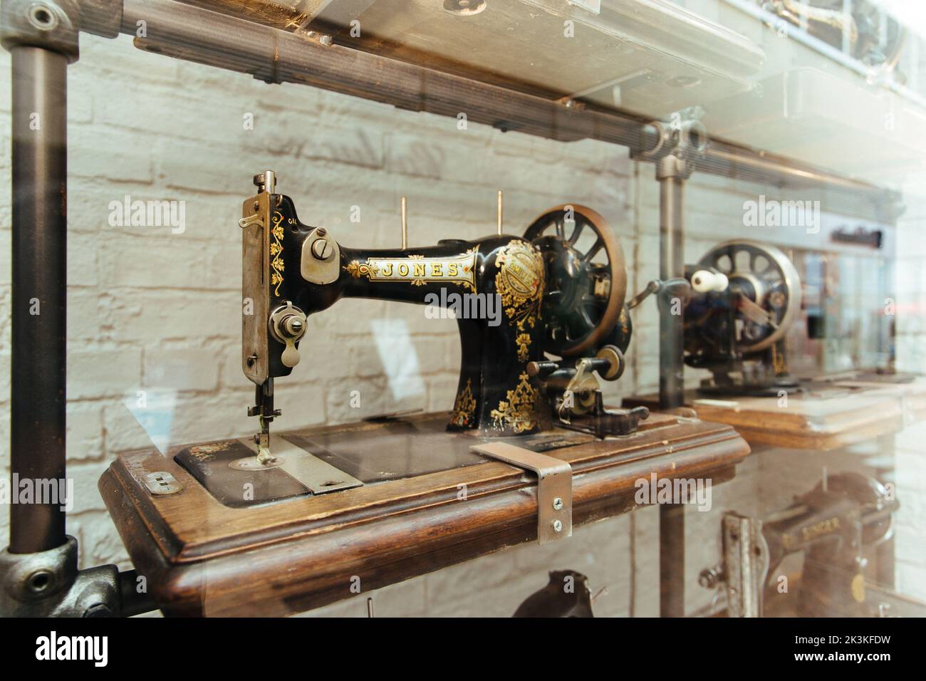A vintage singer sewing machine in shop window display Stock Photo Alamy
