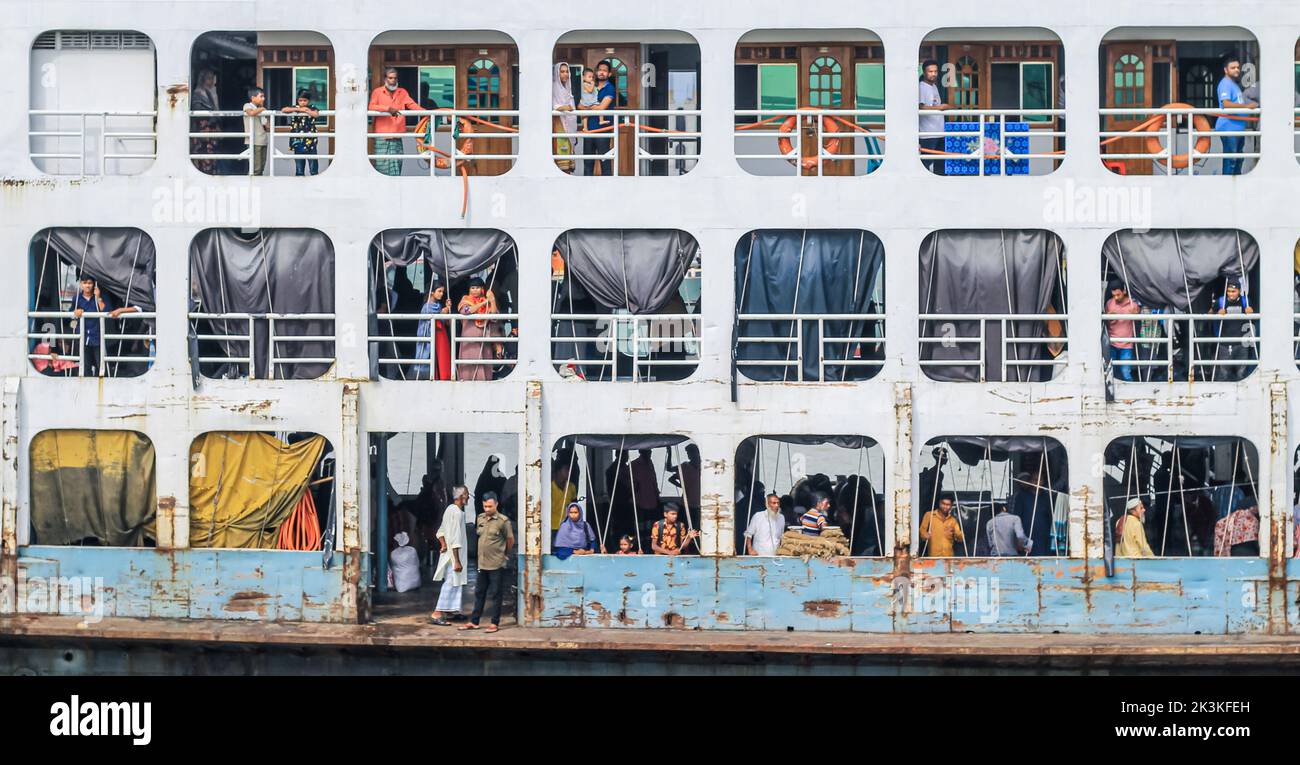 Local people on a ferry at the dock at Sadarghat in Dhaka. Passengers are waiting for their journey end. This is a major port in Bangladesh. Stock Photo
