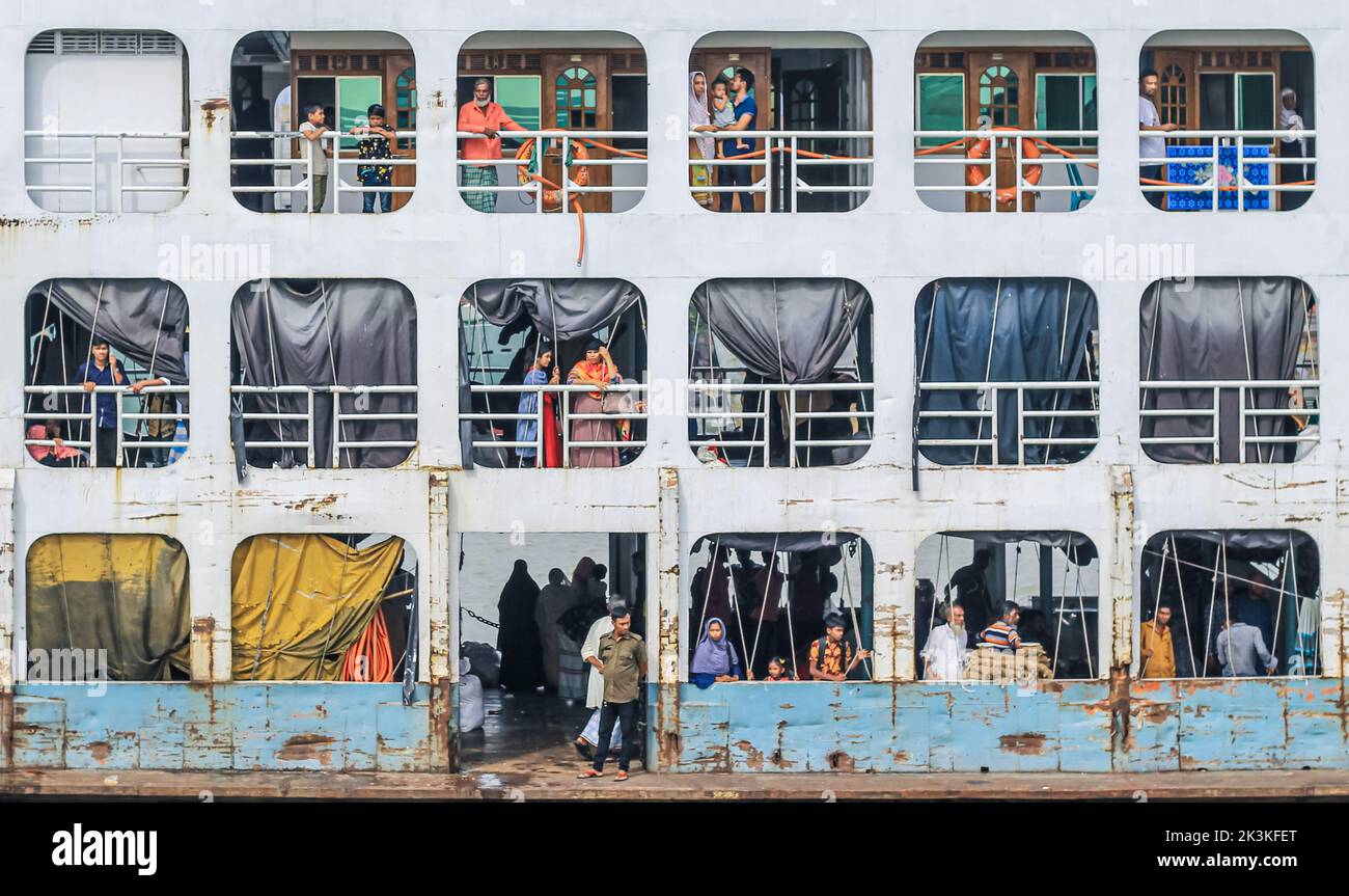 Local people on a ferry at the dock at Sadarghat in Dhaka. Passengers are waiting for their journey end. This is a major port in Bangladesh. Stock Photo