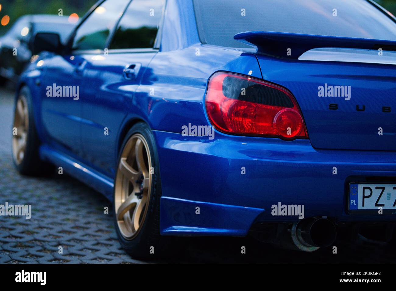 Blue Subaru Impreza WRX Blobeye with gold wheels and smoked taillights
