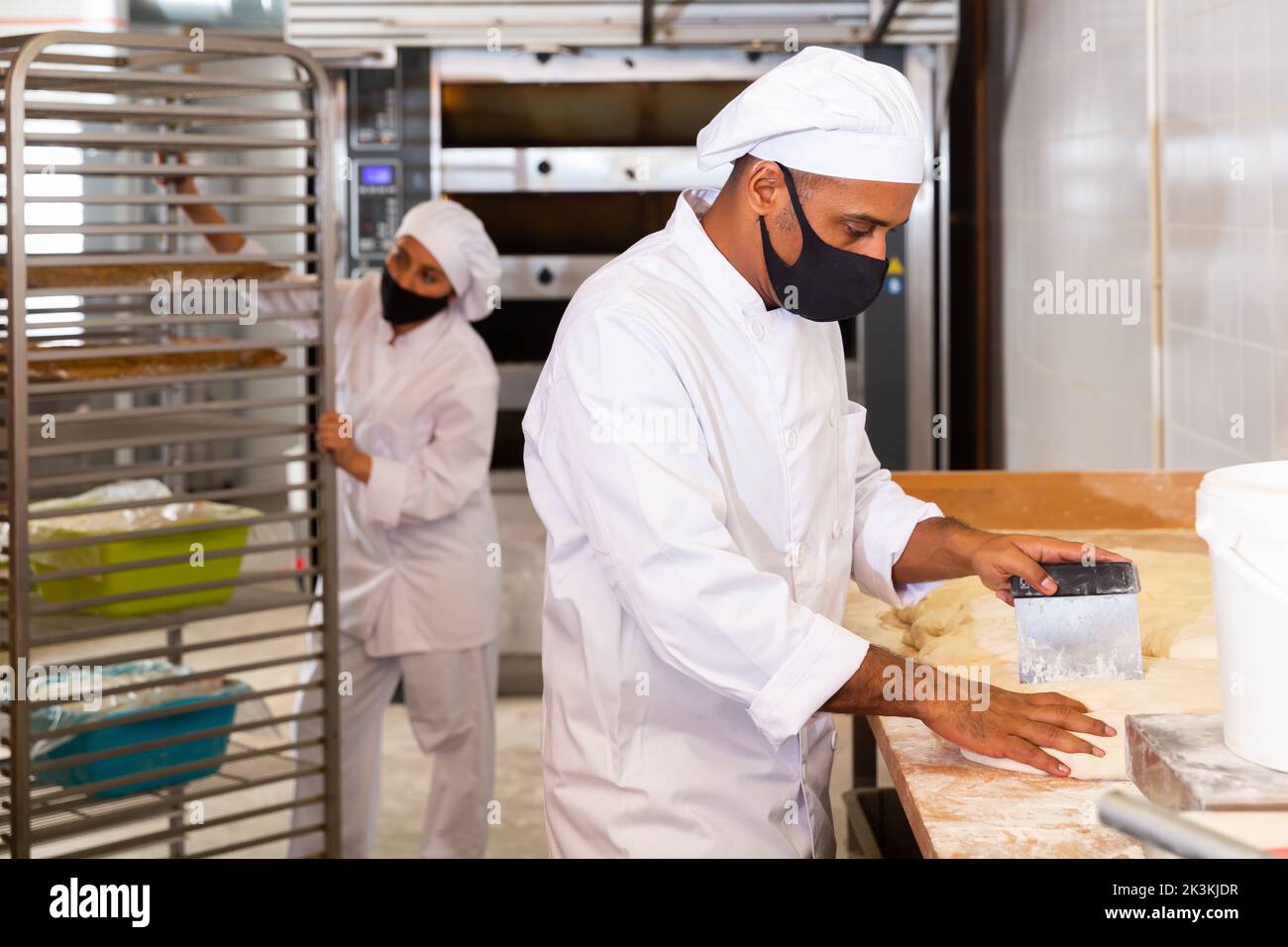 Partition Baking Baker dividing raw dough into equal parts in bakery Stock Photo - Alamy