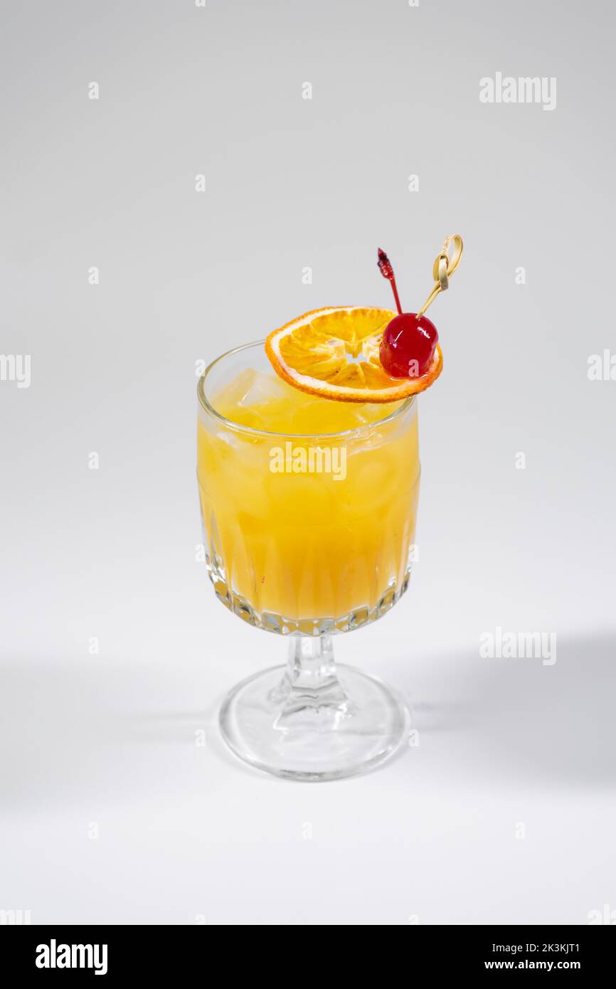 fresh tequila sunrise orange cocktail with slice of citrus isolated
