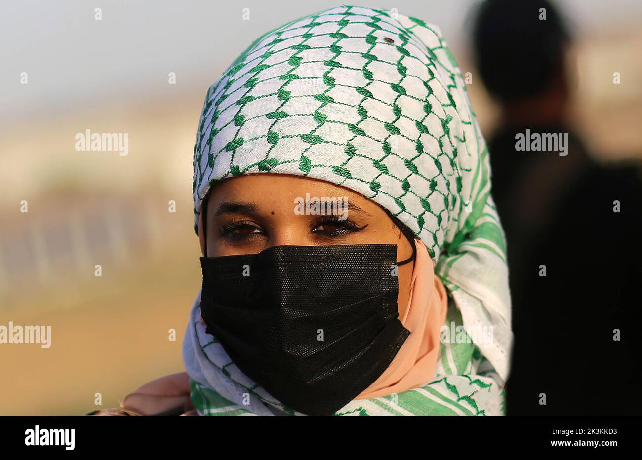 Gaza, Palestine. 26th Sep, 2022. A Palestinian woman wears a black mask during the demonstration in support of Al-Aqsa Mosque 'Al-Quds' near the border fence between Gaza and Israel, east of Gaza City. Protesters anticipate that Israeli settlers will storm Al-Aqsa Mosque during the Jewish holidays. Credit: SOPA Images Limited/Alamy Live News Stock Photo