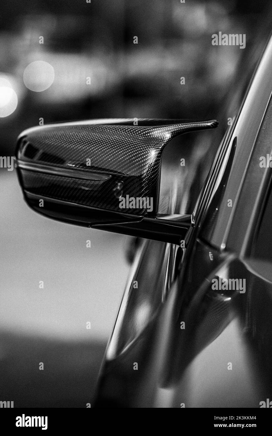 The vertical grayscale partial view of a car sideview mirror Stock
