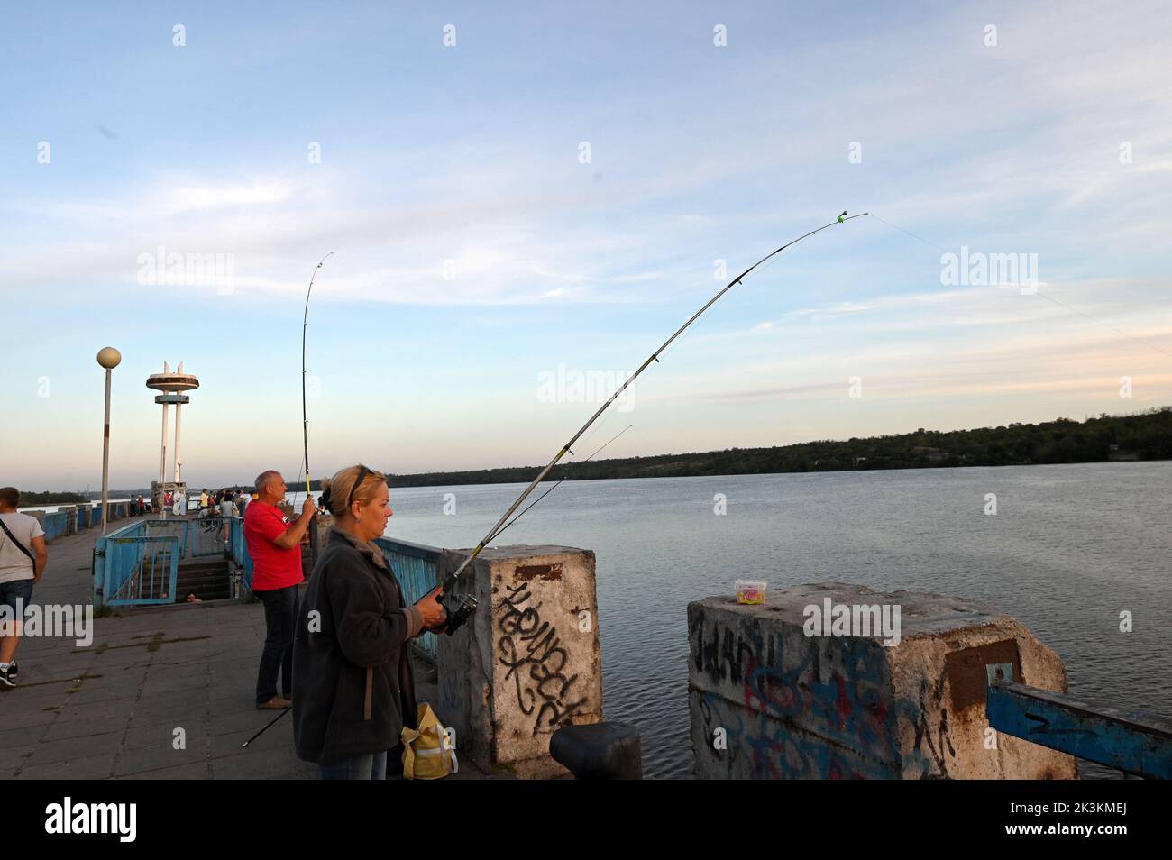 ZAPORIZHZHIA, UKRAINE - SEPTEMBER 2, 2022 - A woman fishes in Zaporizhzhia, southeastern Ukraine. Stock Photo