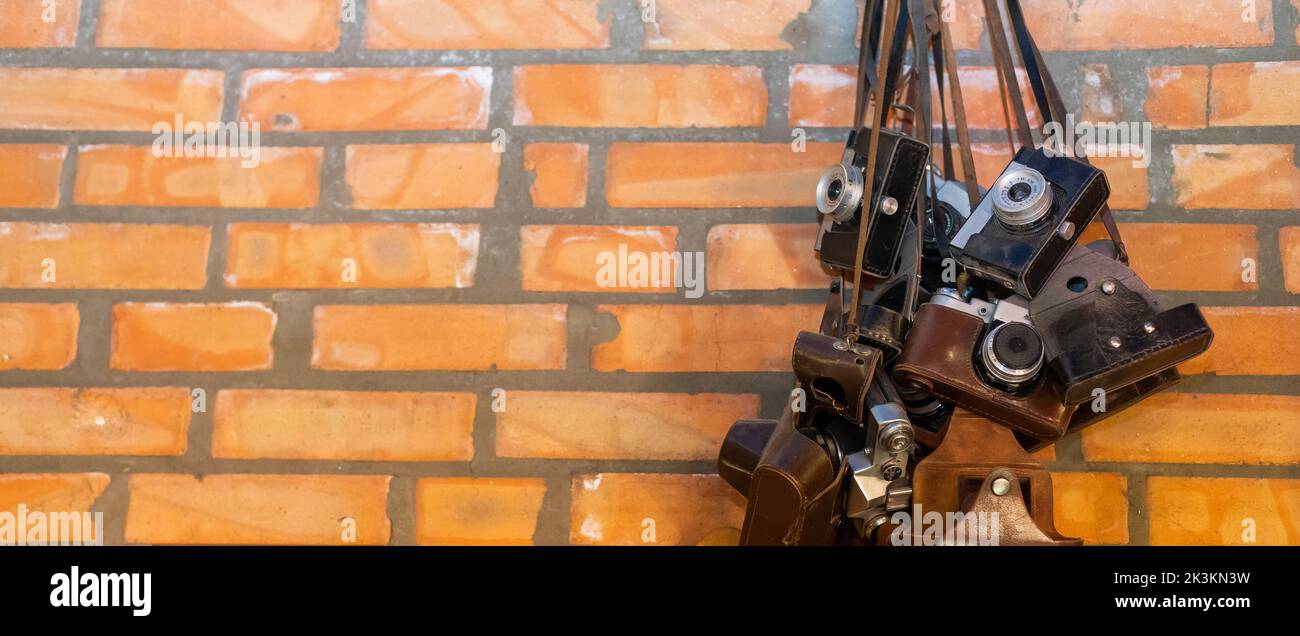 Retro vintage style camera on a old brick wall. Stock Photo