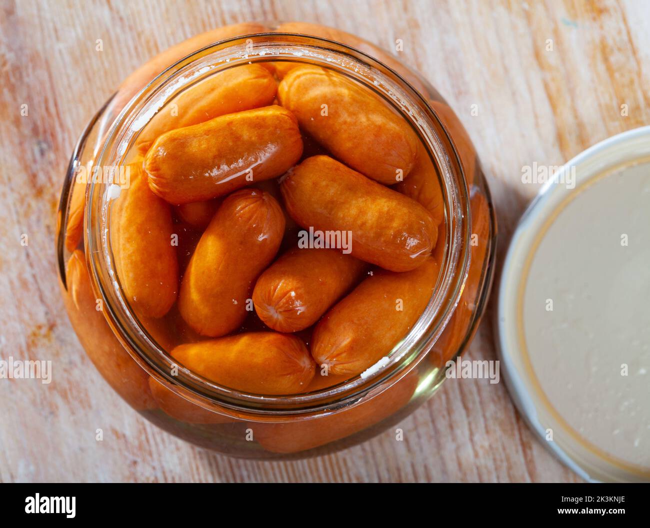 Open jar with preserved mini sausages Stock Photo Alamy