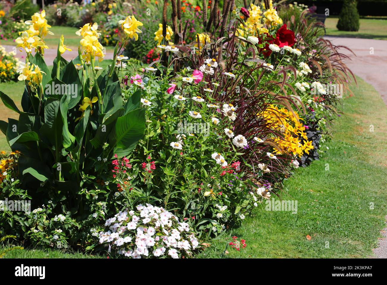 flowerbed with many varieties of fragrant flowers in spring without people Stock Photo