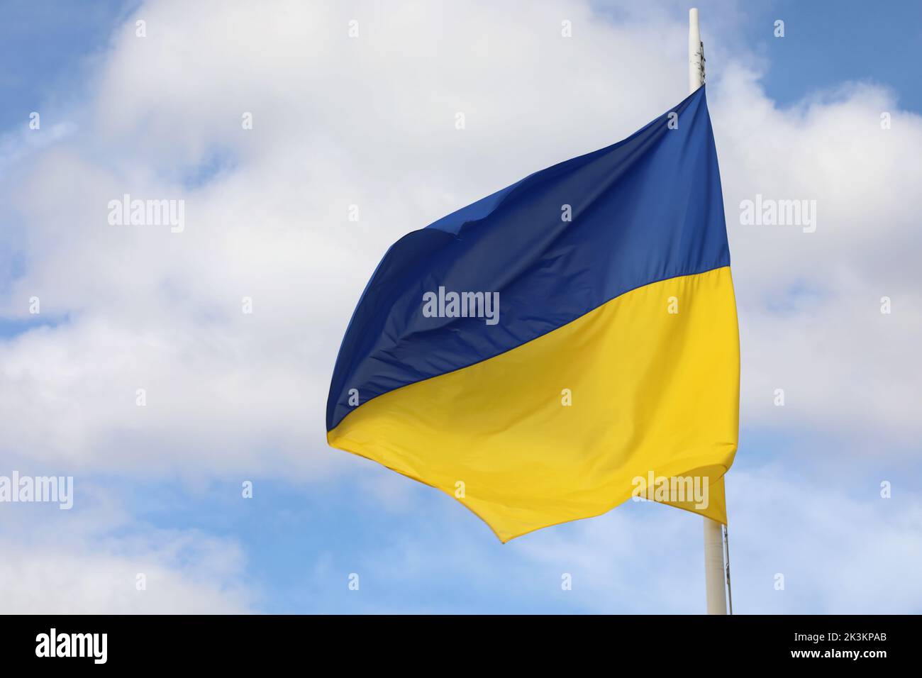 big ukrainian flag on blue sky with blue and yellows colors Stock Photo