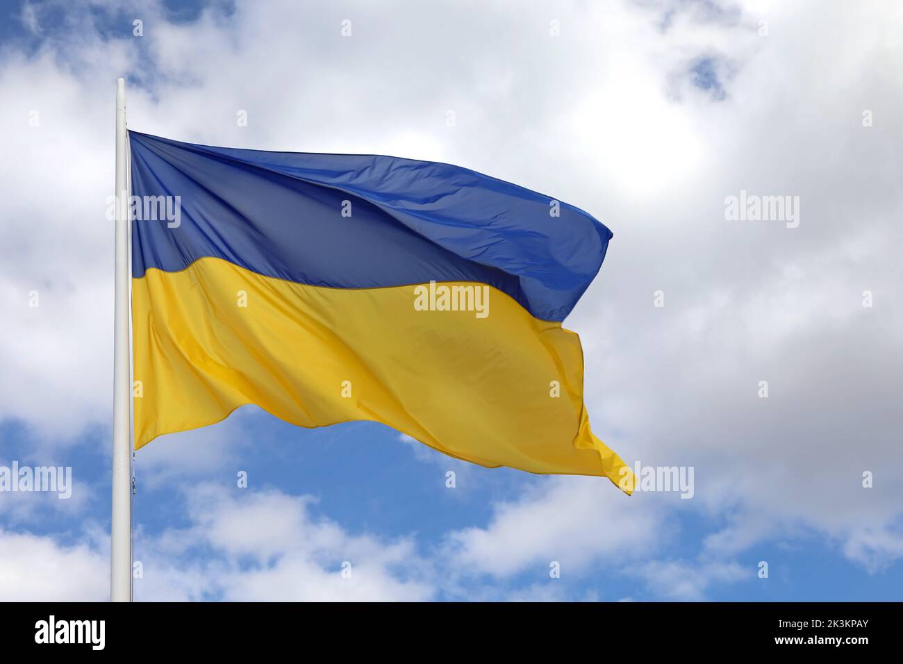 big ukrainian flag on blue sky with blue and yellows colors Stock Photo