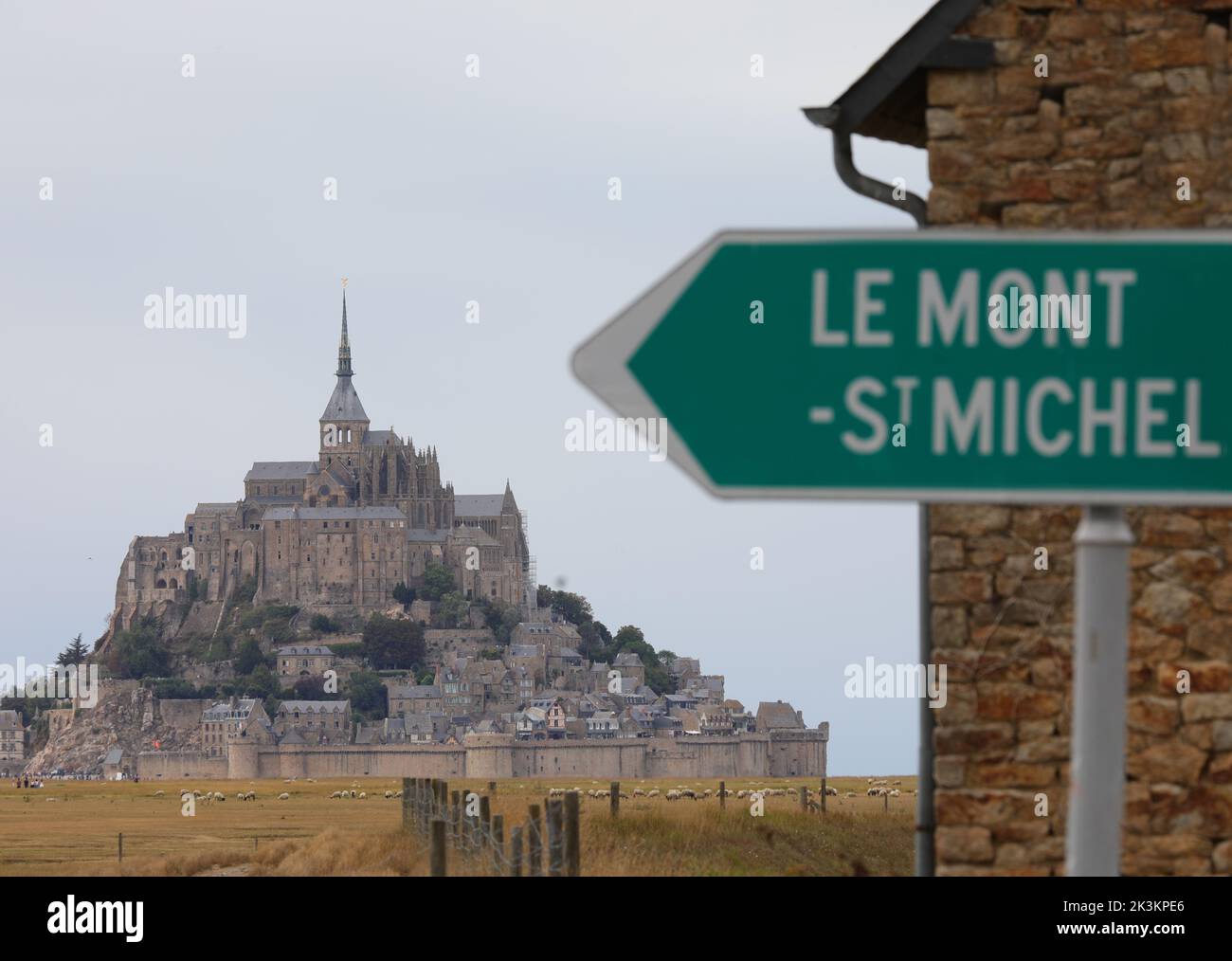 road sign with the inscription Mont Saint Michel and the arrow indicating the ancient abbey Stock Photo